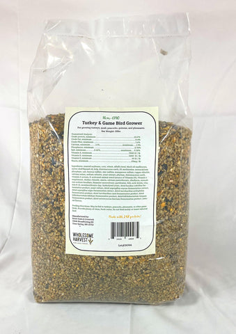 Wholesome Harvest game bird feed being poured from a scoop.