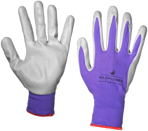 WILDFLOWER Tools gloves worn while yard tools demonstrate protection during garden tasks.
