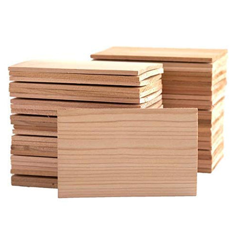 Wildwood Grilling 50-pack cedar planks on a grill ready for restaurant use.