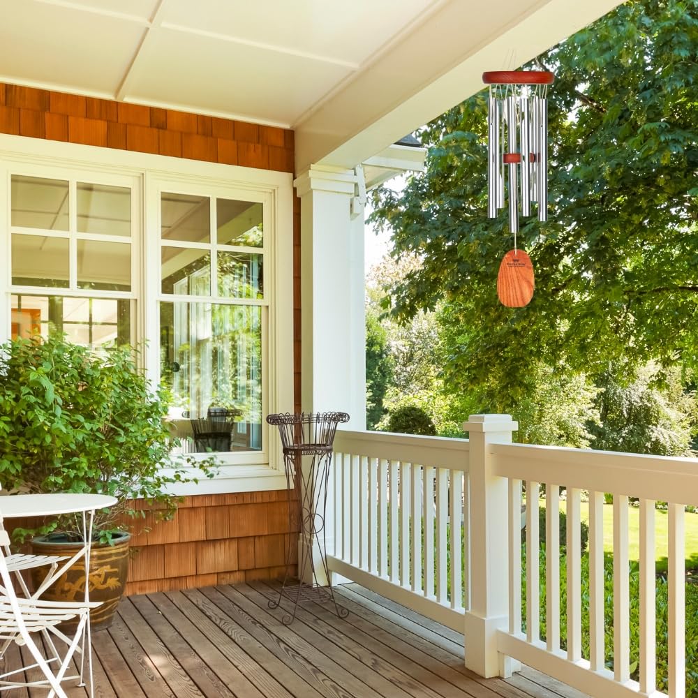 Woodstock Chimes Amazing Grace wind chime placed in a lush garden for tranquil ambiance