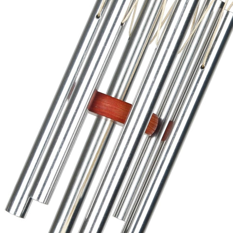 Woodstock Chimes Amazing Grace wind chime on a patio with warm cherry-ash wood look