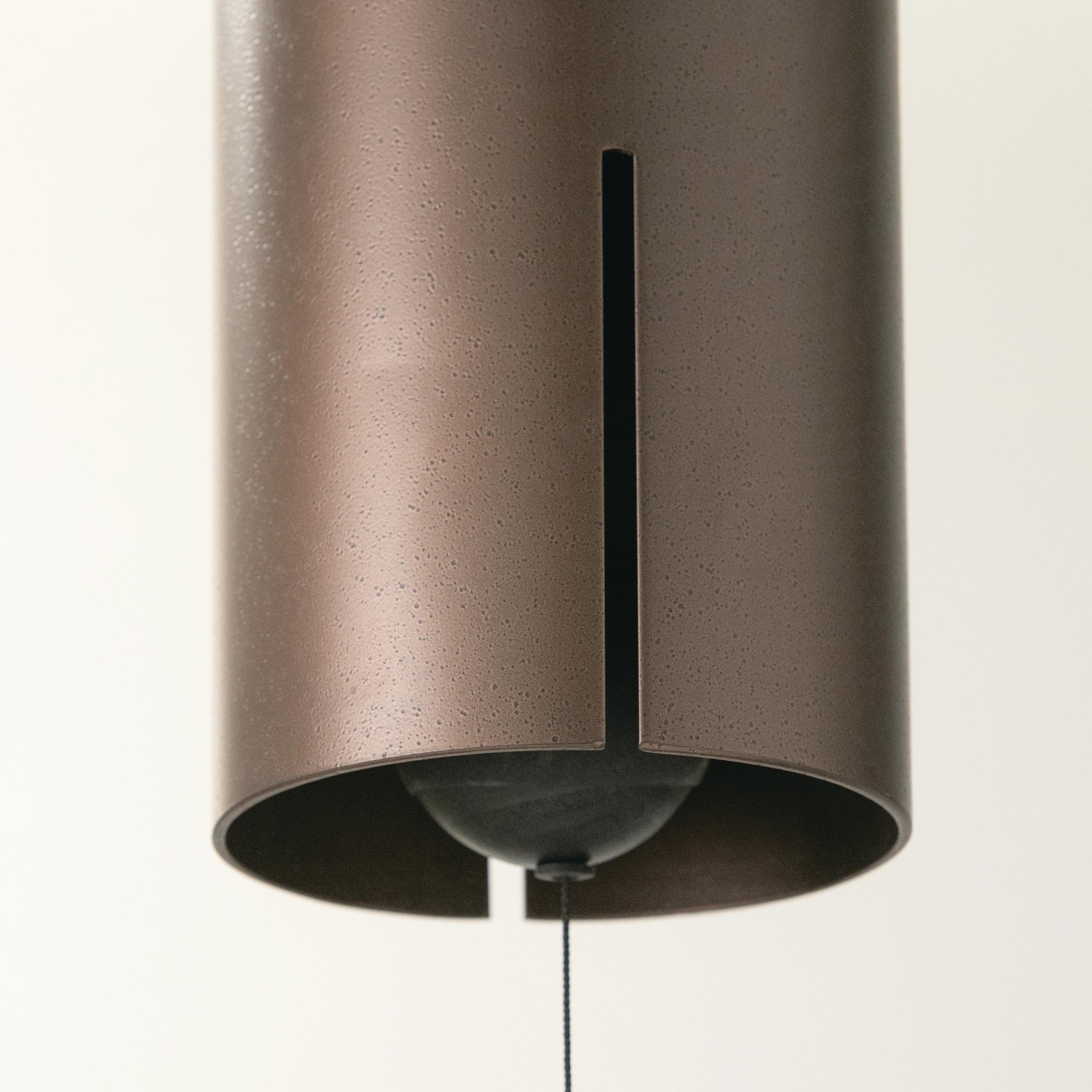 Woodstock Heroic Windbell shown in outdoor garden setting enhances ambience.
