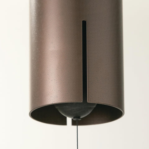 Woodstock Heroic Windbell shown in outdoor garden setting enhances ambience.