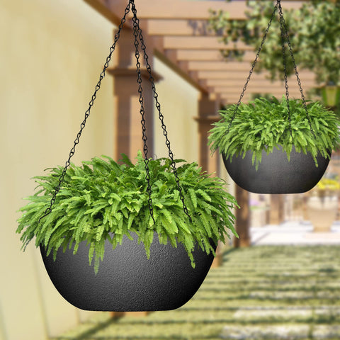 WOUSIWER black plastic planter on a porch demonstrates weather resistance.
