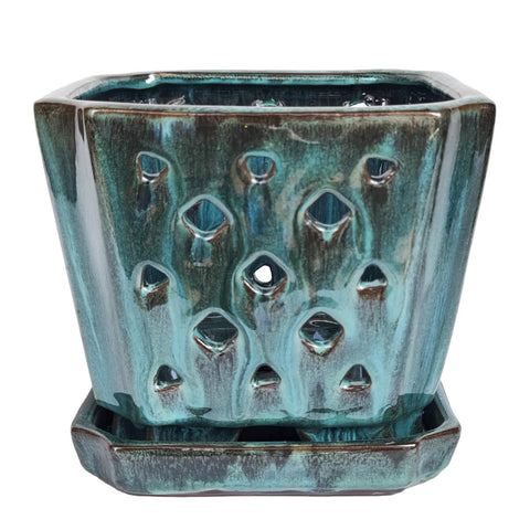 Close-up of drainage holes on the W&amp;W orchid pot highlighting function.