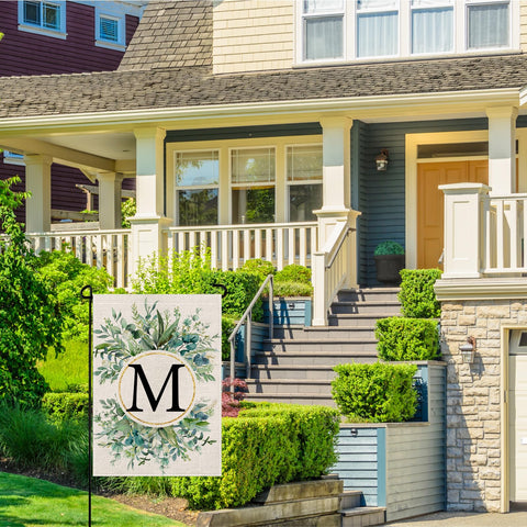Wyooxoo monogram M floral flag creates welcoming outdoor ambiance.