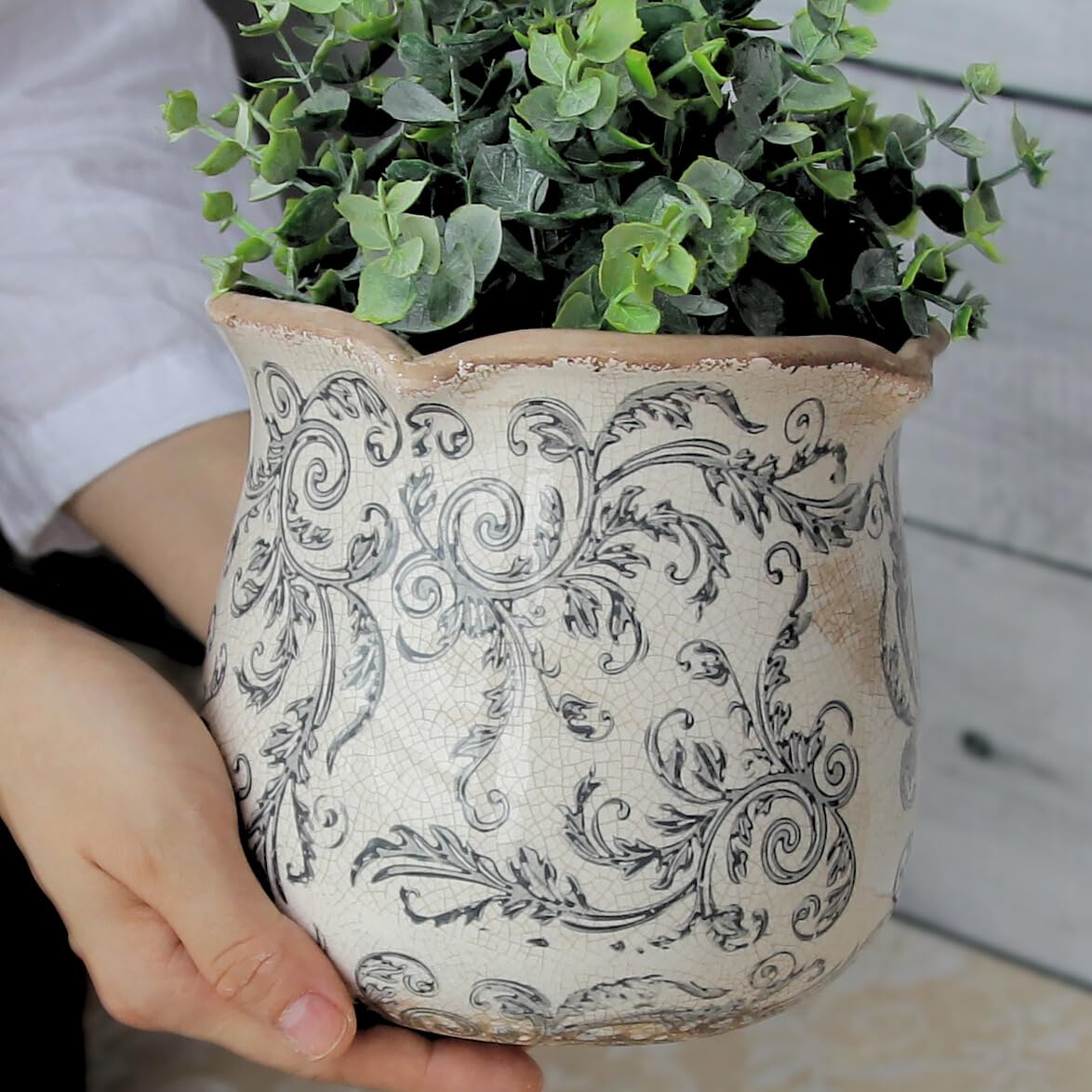 Xiaan Jiaju gray swirl ceramic pot adds rustic warmth to any room.