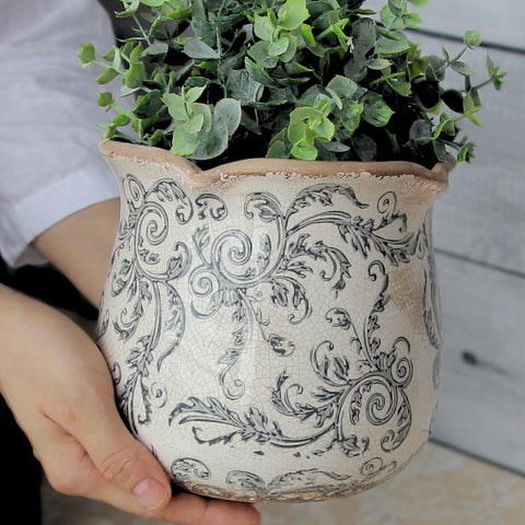 Xiaan Jiaju gray swirl ceramic pot adds rustic warmth to any room.