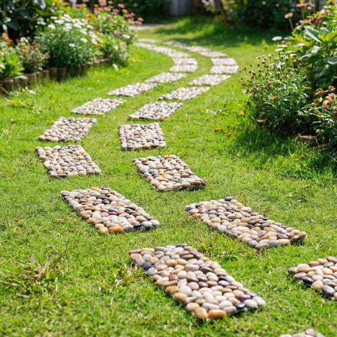 Xindian river rock stepping mats blend with gravel for a cohesive yard look.