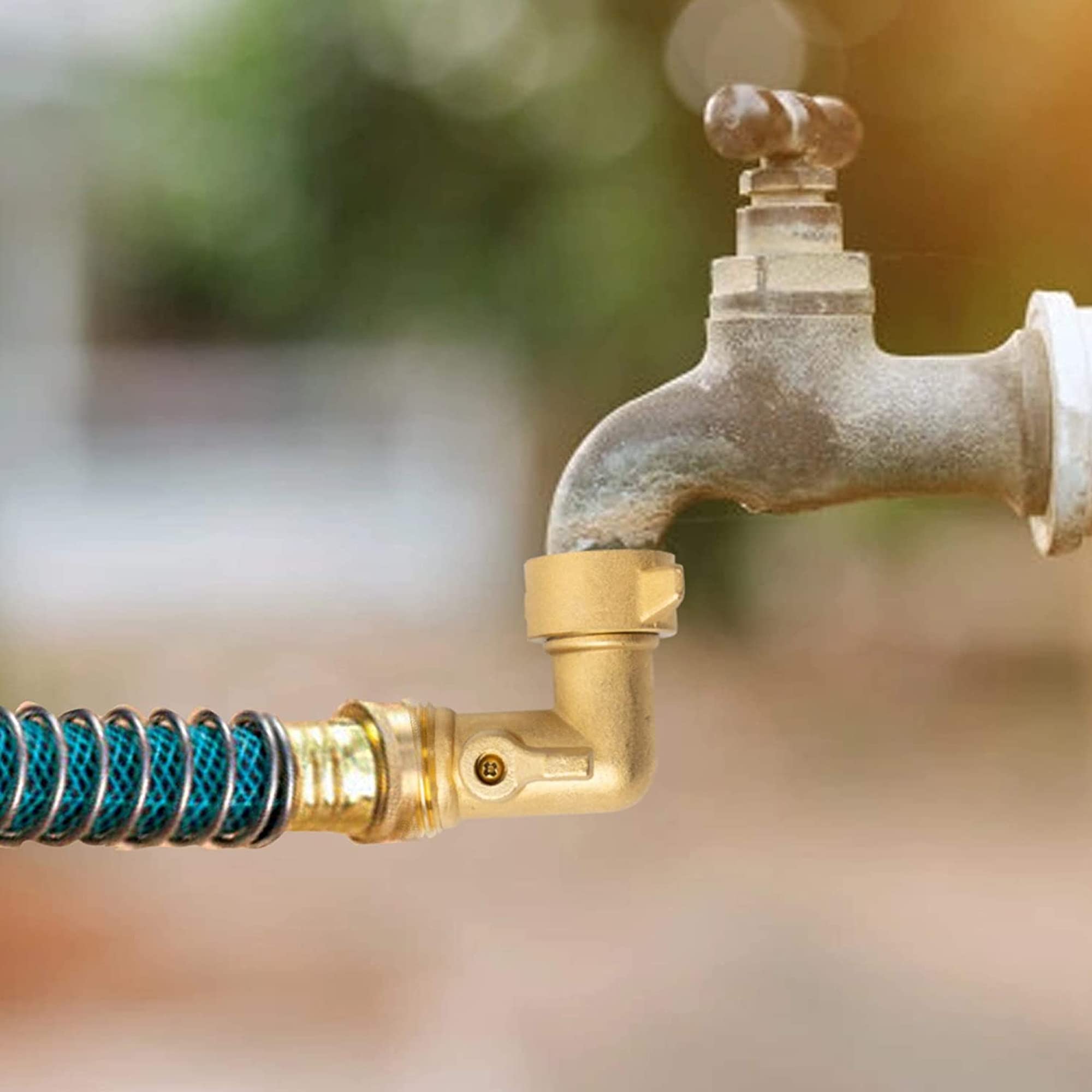 Xiny Tool installation on an outdoor faucet with hose for versatile setup.
