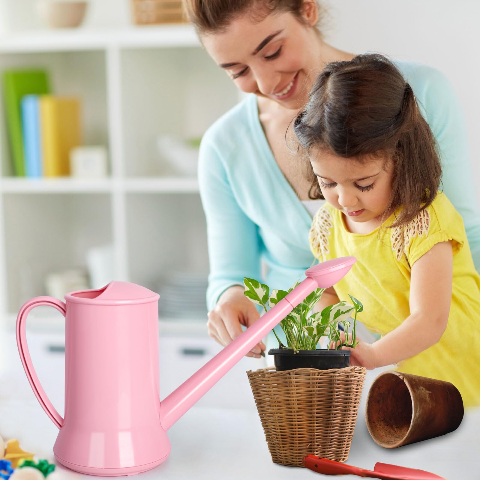 Extended view of XXXFLOWER pink can with long spout for reach.