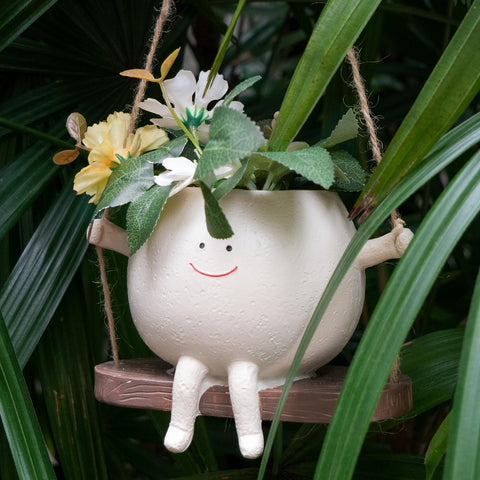Xzunk outdoor display with swing planters adds charm to a garden or patio.