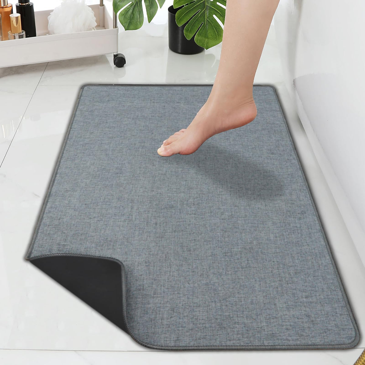 Yancorp ultra-thin bath rug under door for seamless placement and space-saving coverage.