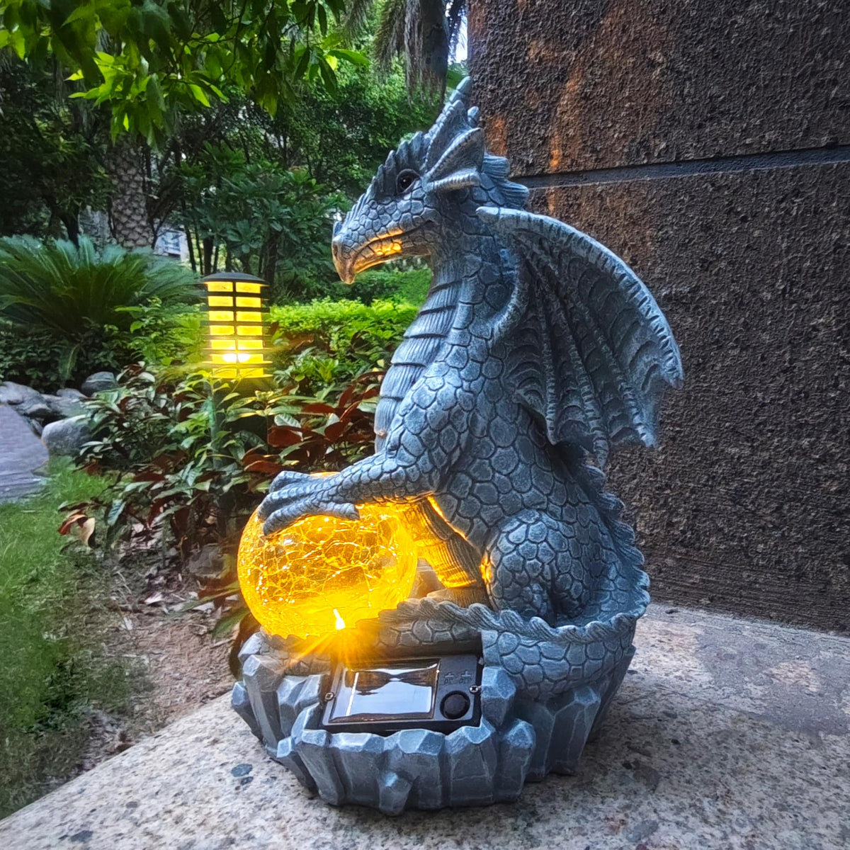 Yardancer Dragon Solar Garden Statue with crystal ball glows at night.