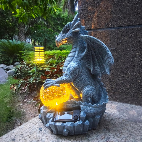 Yardancer Dragon Solar Garden Statue with crystal ball glows at night.