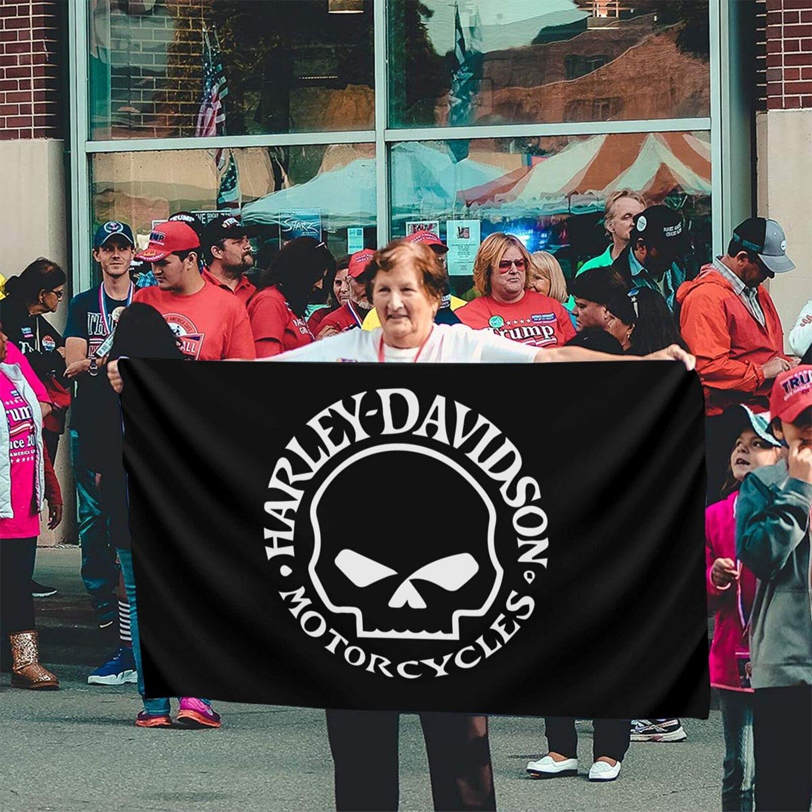 YIKUDU SARAH SCOTT flag displayed outdoors in light wind.