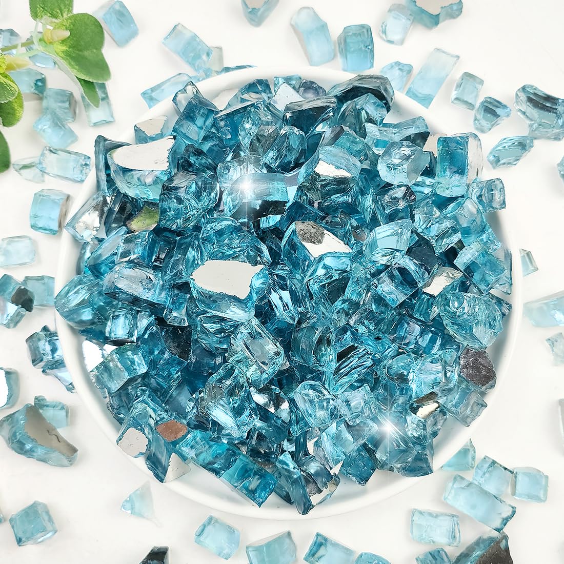YISZM Aqua Blue half-inch fire glass rocks gleam in a propane fire pit for dramatic ambience.