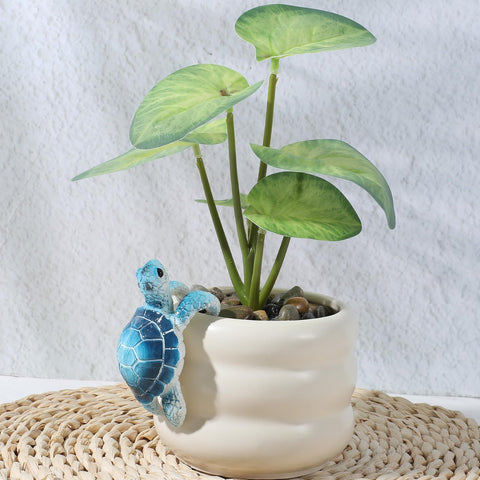 Yolev climbing tortoise figure decor brings personality to small plant displays.