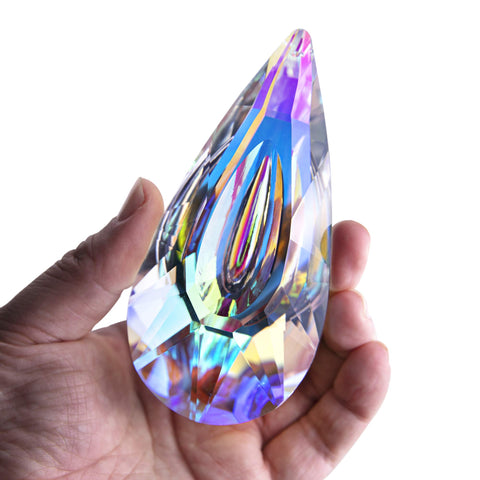 YU FENG 120mm crystal prism suncatcher in sunlight casts vivid rainbows on a window