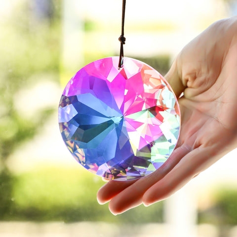 YU FENG AB-colored crystal prism creating subtle rainbow reflections