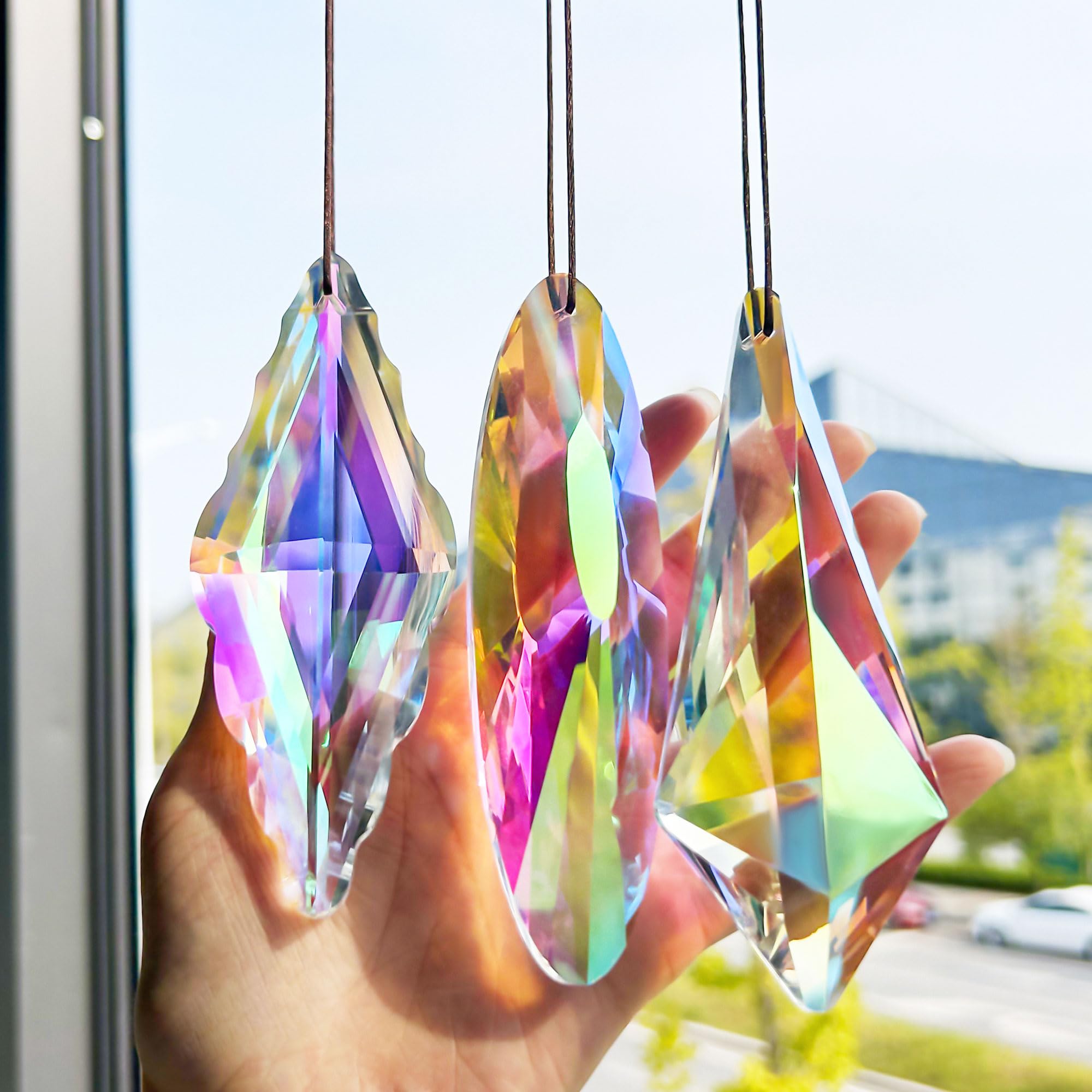 YU FENG crystal prism suncatcher on a window creates a vivid rainbow across the room