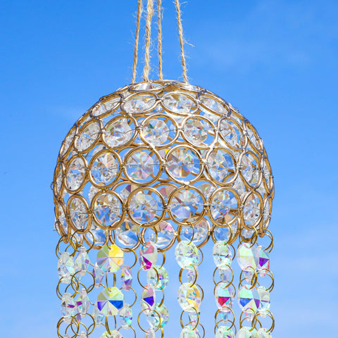 YU FENG gold frame with moon and leaf charms on a sun catcher
