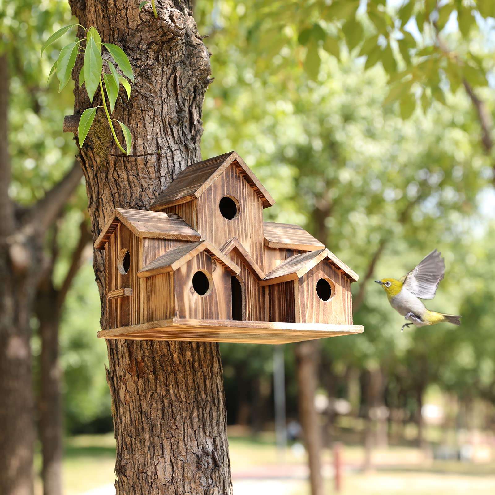 YYYUAN handmade hummingbird house in the garden attracts birds and adds outdoor charm.