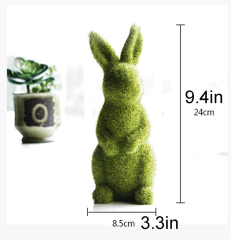 Zensounding Easter bunny sitting on moss adds desk charm.