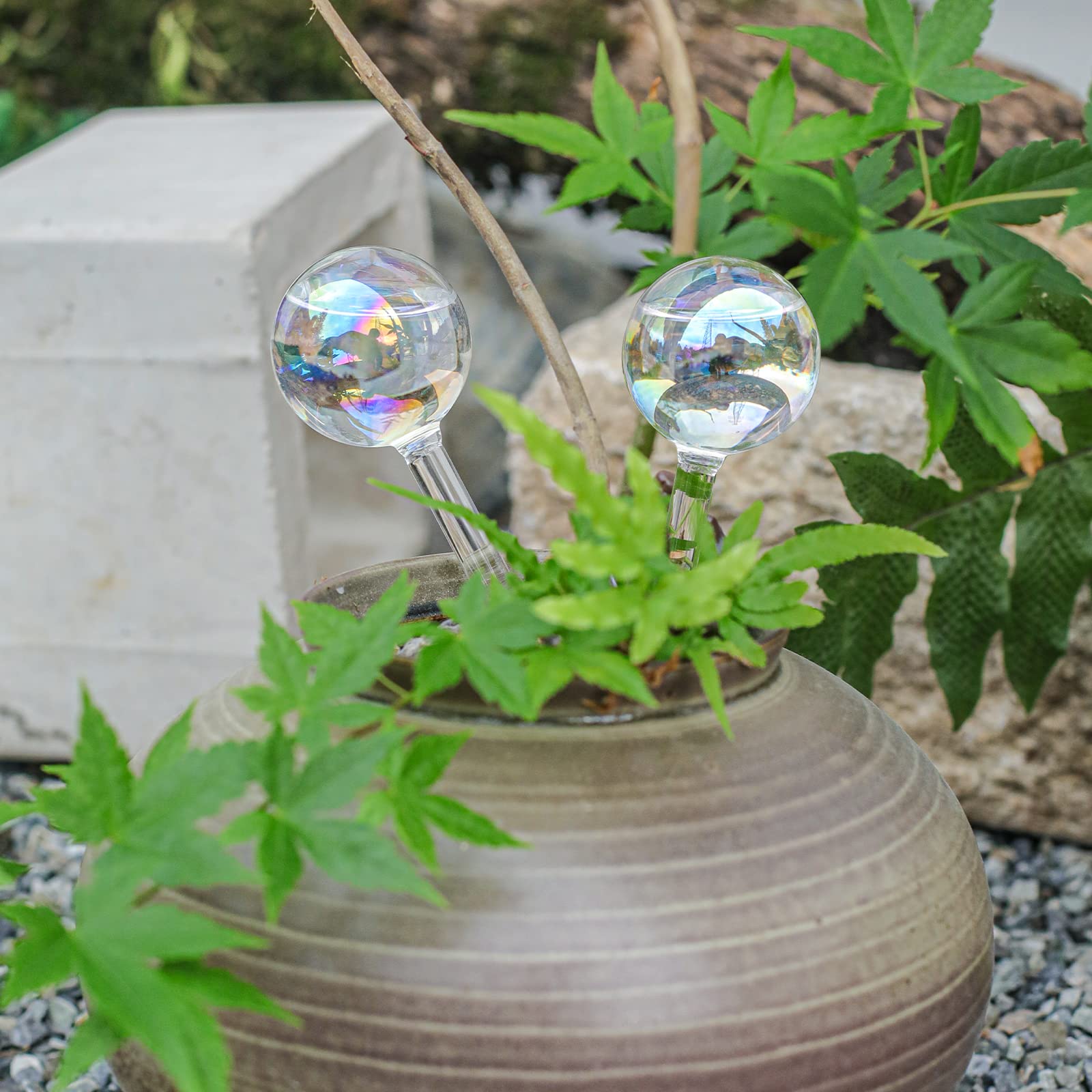 zHzHGuo iridescent globe decorates a shelf with greenery.