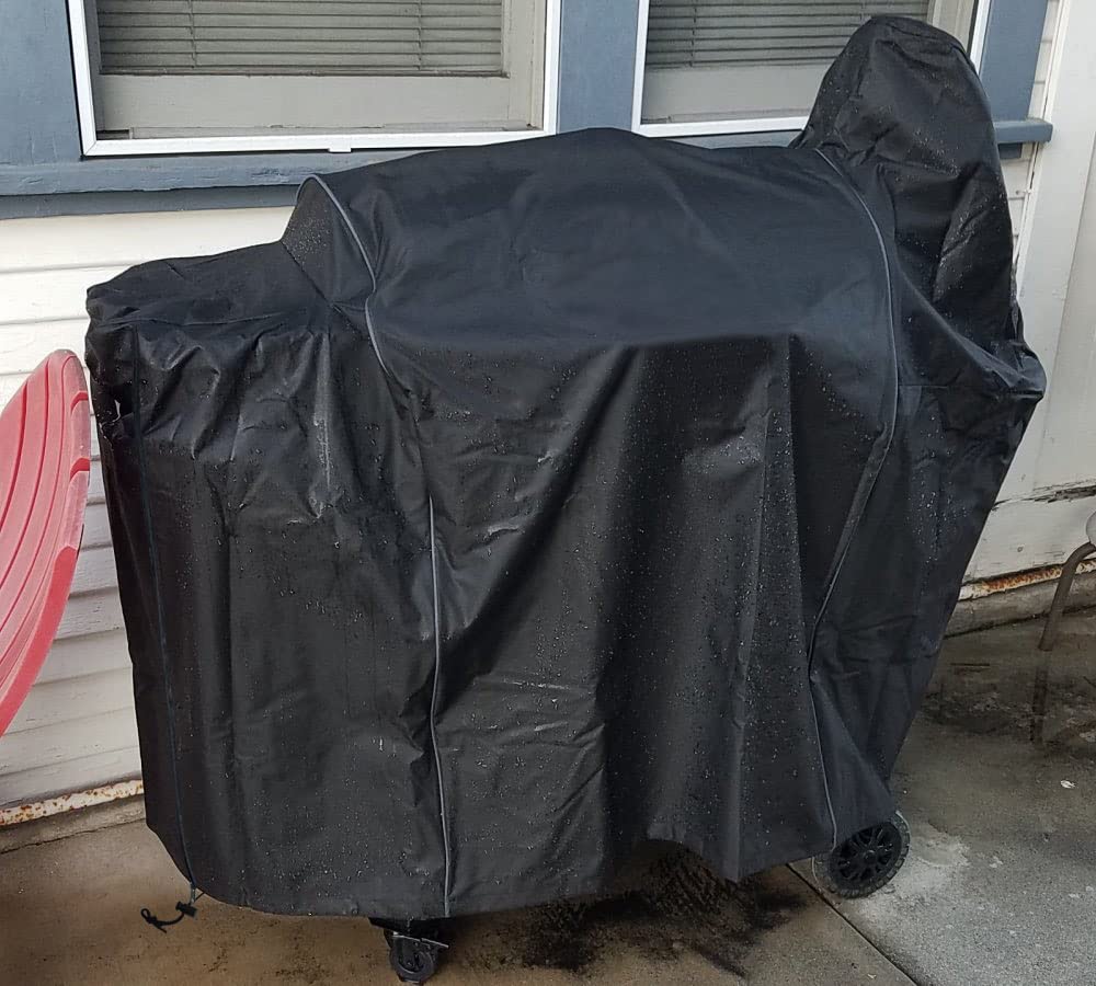 ZJYWSCH cover mounted on grill in backyard setting.